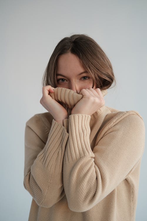 Woman crouching and posing in casual attire