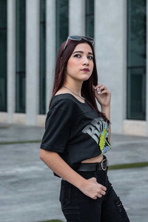 Woman crouching and posing in casual attire