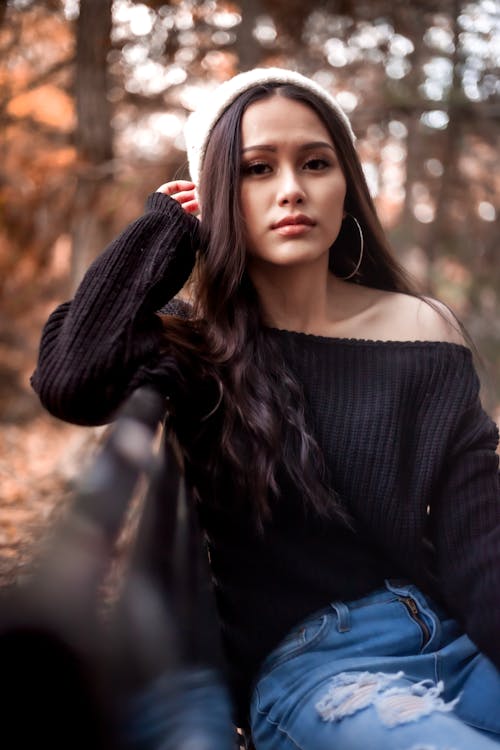 Woman crouching and posing in casual attire