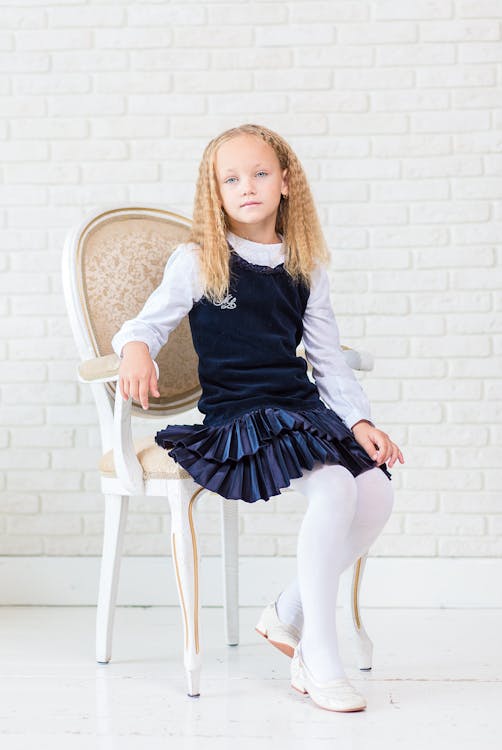 Woman crouching and posing in casual attire