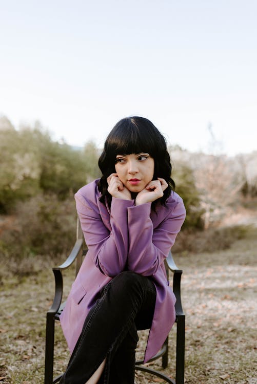 Woman crouching and posing in casual attire