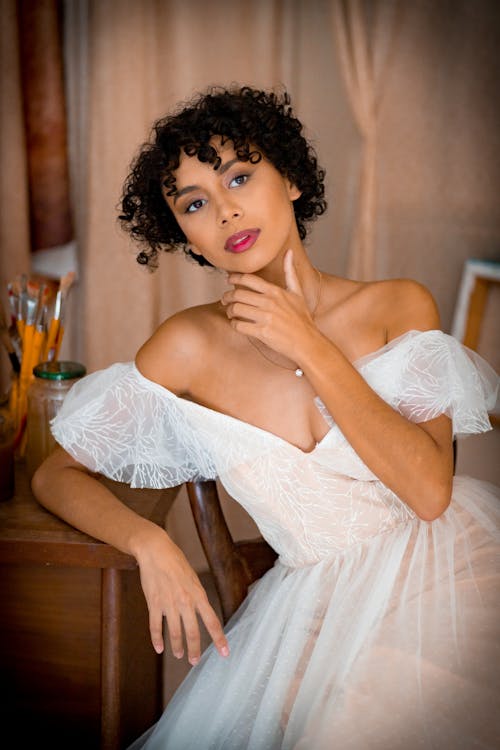 Woman crouching and posing in casual attire