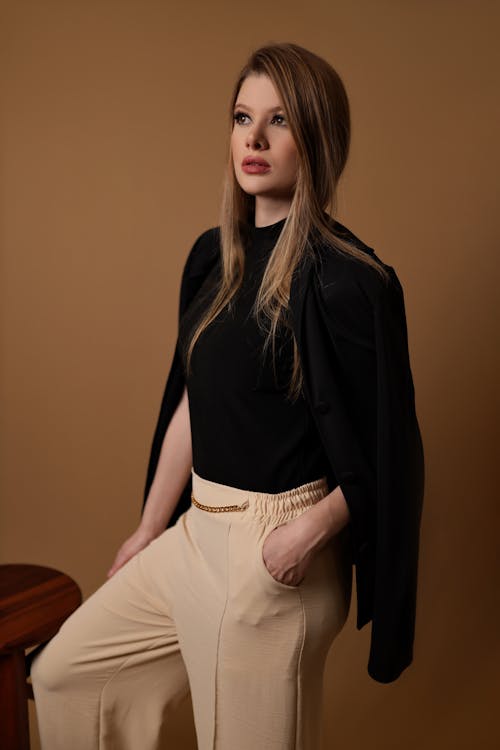 Woman crouching and posing in casual attire