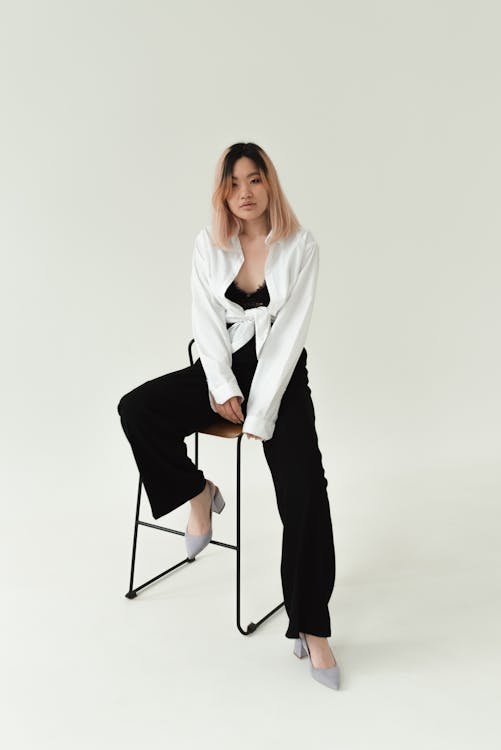 Woman crouching and posing in casual attire
